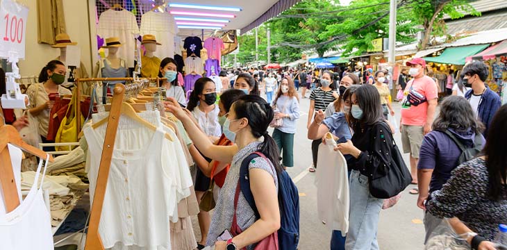 Unidentified people wear surgical mask and choosing new clothing dress at Chatuchak market