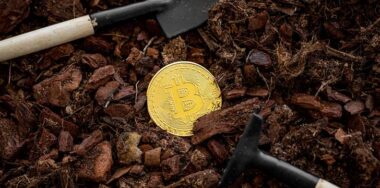 Bitcoin on the ground with shovel and pike