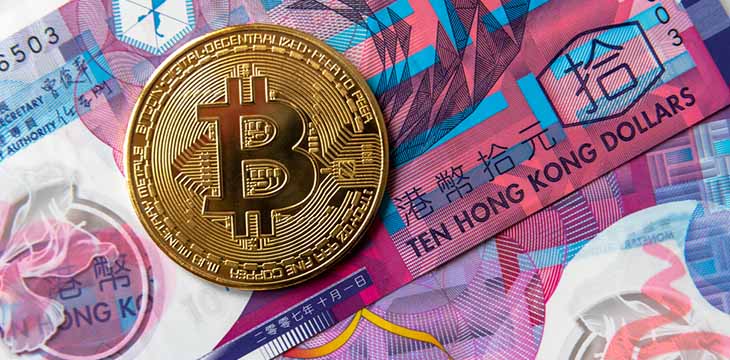 gold Bitcoin on top of hong kong dollars