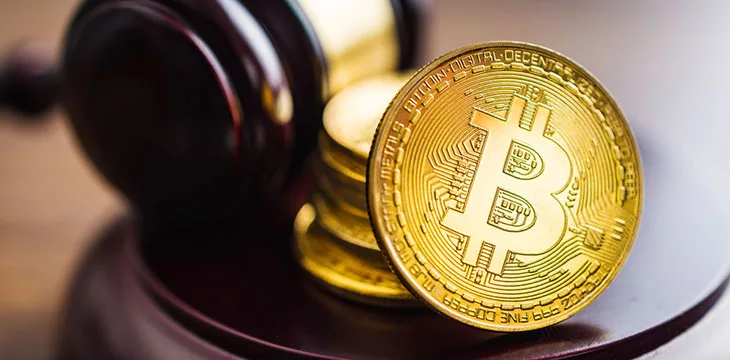 Golden coins and the judge gavel. Bitcoin Cryptocurrency concept.