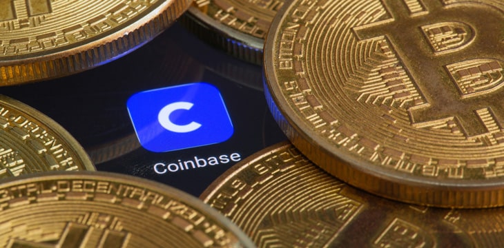 Coinbase logo app surrounded with gold bitcoins