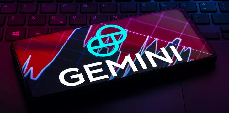 Gemini logo on a phone screen on top of a keyboard
