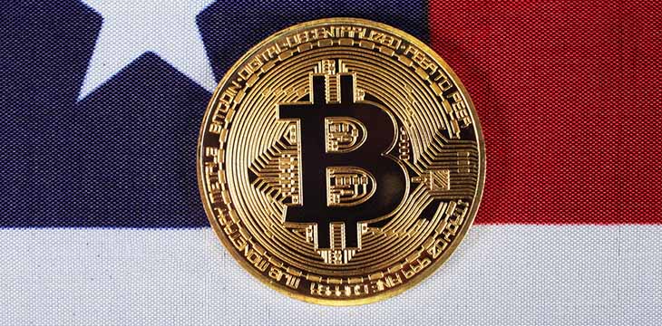 Golden bitcoin on usa flag, closeup, top view