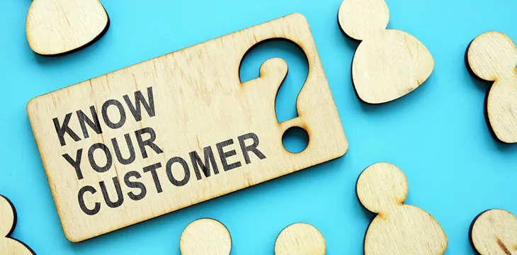 Know your customer phrase on wooden plate with skyblue background