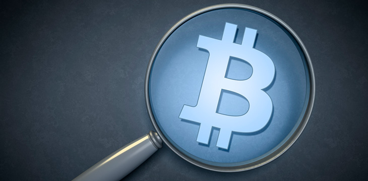 bitcoin sign on a magnifying glass