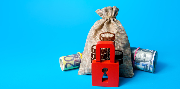 Money, money bag, and red padlock with blue background