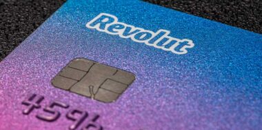 Payment card belonging to the Revolut electronic bank on a black background, macro shot, mobile banking