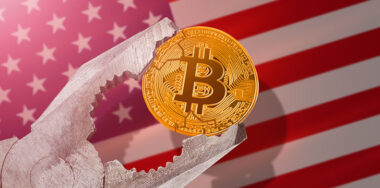 bitcoin btc coin being squeezed in vice on United States flag background