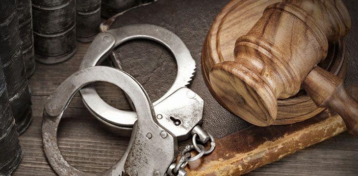 handcuffs, judge gavel, and law book