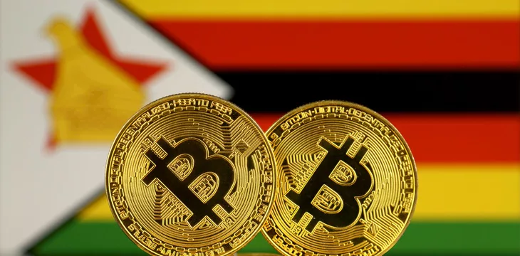Physical version of Bitcoin and Zimbabwe Flag