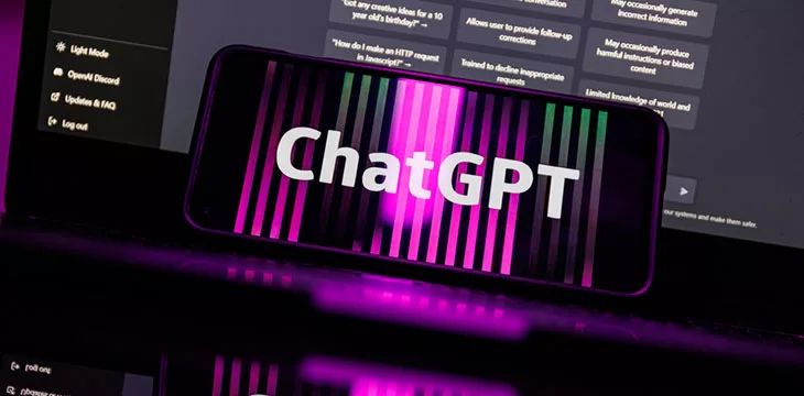 ChatGPT logo on phone screen in front of computer screen