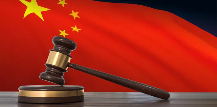 Waving flag of China and a wooden gavel