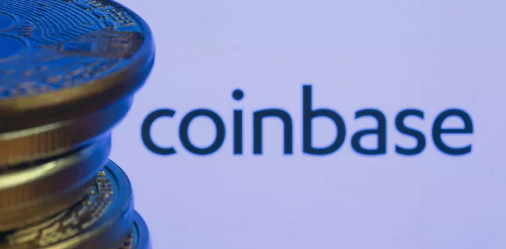 Coinbase logo and Bitcoins with purple background