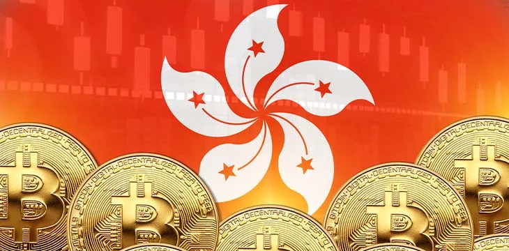 gold bitcoins in front of hong kong flag