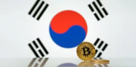 Golden bitcoin stands on a blurred background of state flag of South Korea