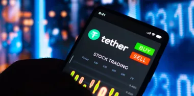 n this photo illustration, the stock trading graph of Tether (USDT) seen on a smartphone screen