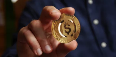 USDC USD Coin stablecoin cryptocurrency golden coin in hand abstract concept