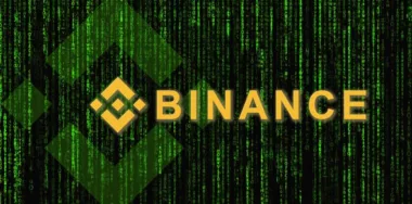 binance logo in front of binary code background