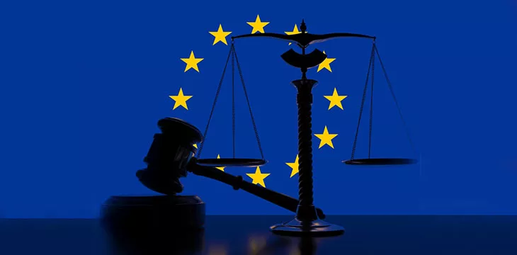 Flag of the European Union behind court gavel and scales
