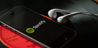 spotify logo on iphone with earphones on the side
