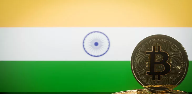 gold bitcoin in front of an indian flag