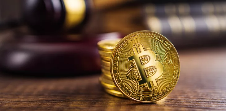 Cryptocurrency. Bitcoin virtual money. Golden coins and the judge gavel