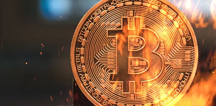 Bitcoin cryptocurrency money burning in flames and fire sparkles