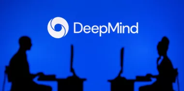 Silhouette of Software Developers with DeepMind Logo Behind Them