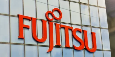 Logo Fujitsu closeup, a Japanese multinational information technology equipment and services company booth