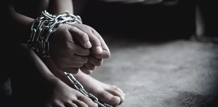 Hopeless man hands tied together with chain