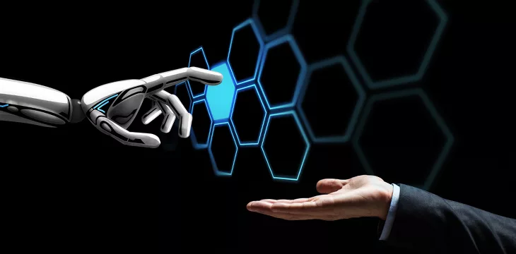 Artificial intelligence concept. Human hand and robot touching network hologram
