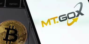 MT.GOX logo on screen smartphone with bitcoin. MT.GOX is popular largest cryptocurrency exchange on the market.