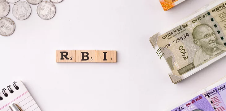 RBI scrabble letters with money and notepad around it