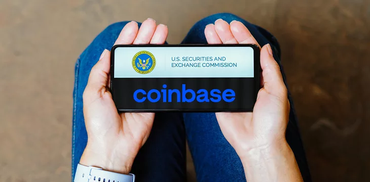 Securities and Exchange Commission (SEC) and Coinbase logo is displayed on a smartphone screen