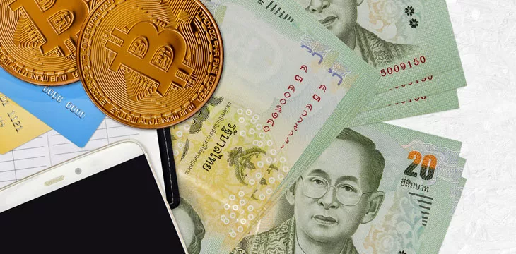 20 Thai Baht bills and golden bitcoins