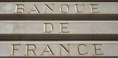 Closeup of Bank of France sign on stoned building in golden letters