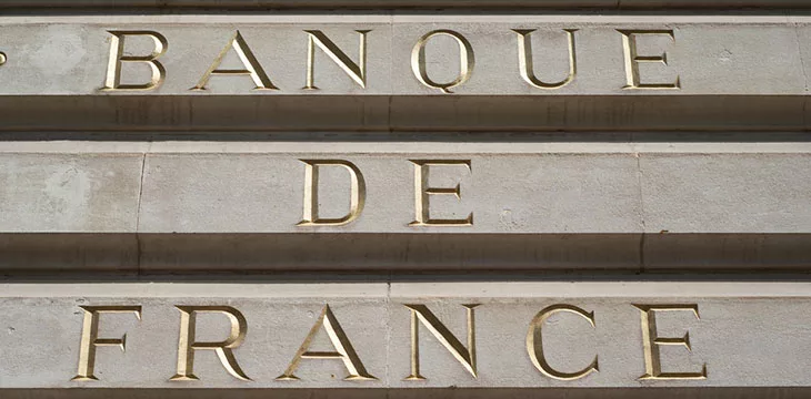 Closeup of Bank of France sign on stoned building in golden letters