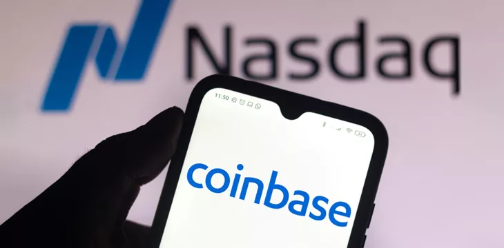 In this photo illustration the Coinbase logo seen displayed on a smartphone screen with the logo of Nasdaq in the background