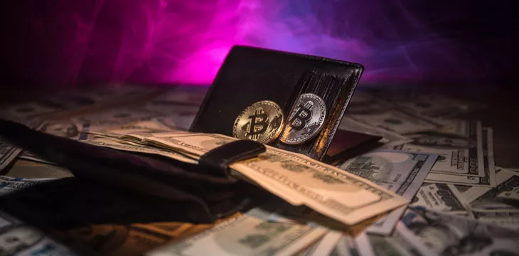 Bitcoin with dollar in purse. Profit from mining crypto currencies