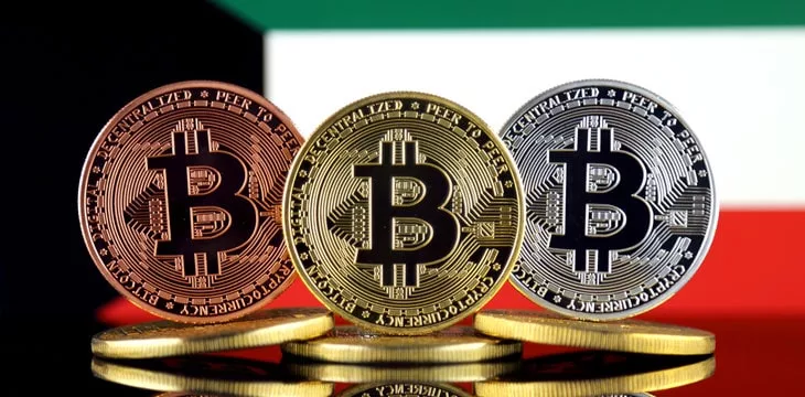 Physical version of Bitcoin (BTC) and Kuwait Flag. Conceptual image for investors in High Technology