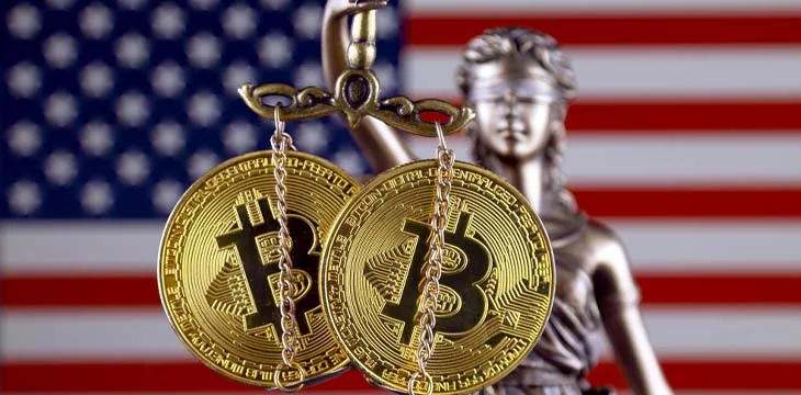Symbol of law and justice, physical version of Bitcoin and United States Flag