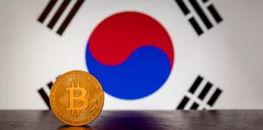 gold bitcoin with south korean flag in the background