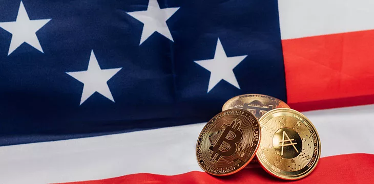 Different cryptocurrency coins on an United States flag