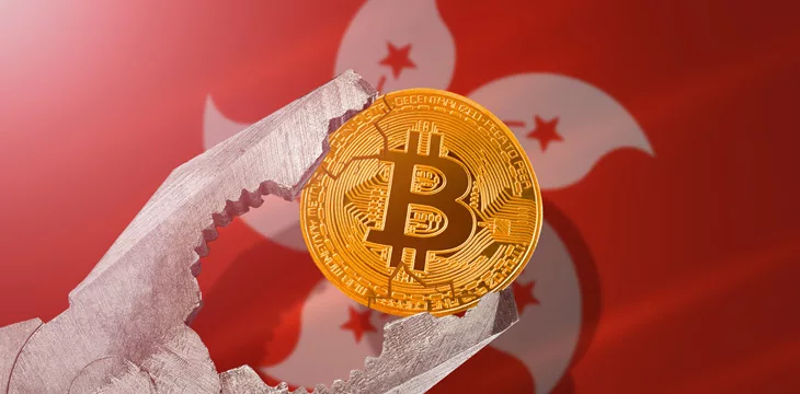 Bitcoin regulation in Hong Kong; bitcoin btc coin being squeezed in vice on Hong Kong flag background; limitation, prohibition, illegally, banned