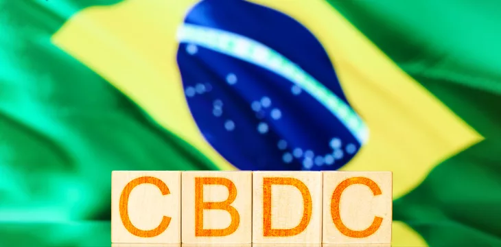 wooden cubes with the inscription cbdc on the background of the national flag of brazil