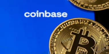 Coinbase app with gold bitcoin coins on smartphone