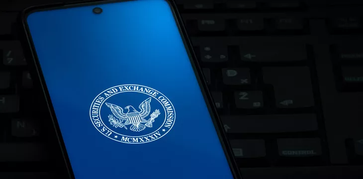 Securities and Exchange Commission logo on phone screen in blue background