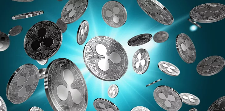 Scattered Ripple coins on a lighted background. Success and growth concept.
