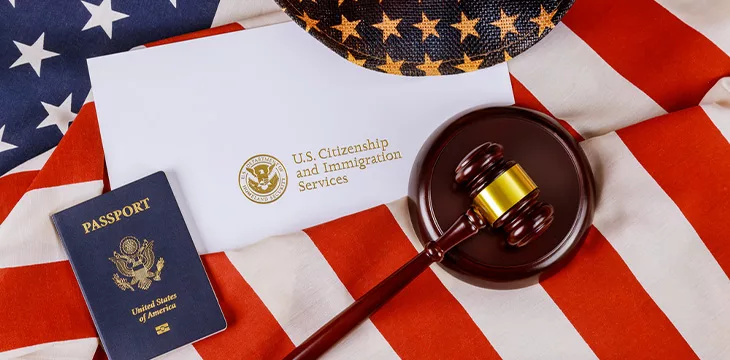 US passport over Letter from U.S. Citizenship and Immigration Services of naturalization with in a judge law gavel