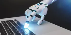 Futuristic robot hand typing and working with laptop keyboard